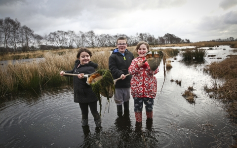 Children use nets in water