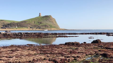 A view across Kimmeridge Bay towards Clavell Tower at low tide